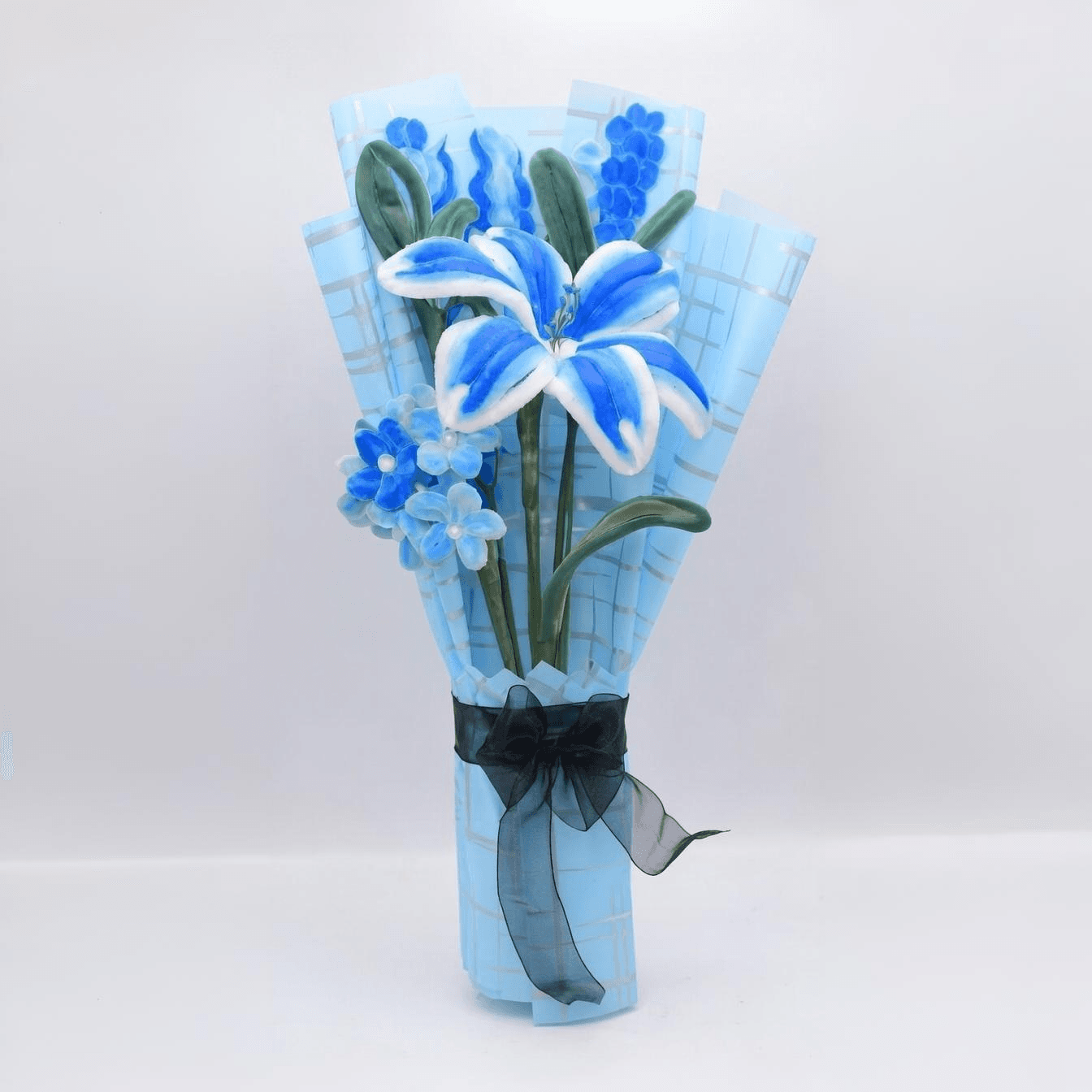 Ocean Breeze Lily Bouquet – A stunning arrangement of blue lilies with lush greenery.